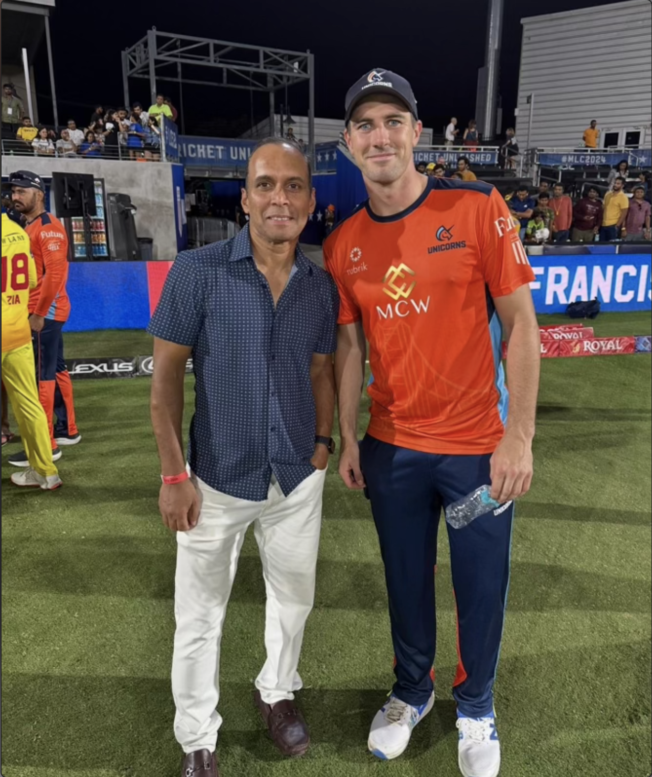 Kevin Rego with a cricketer at a stadium
